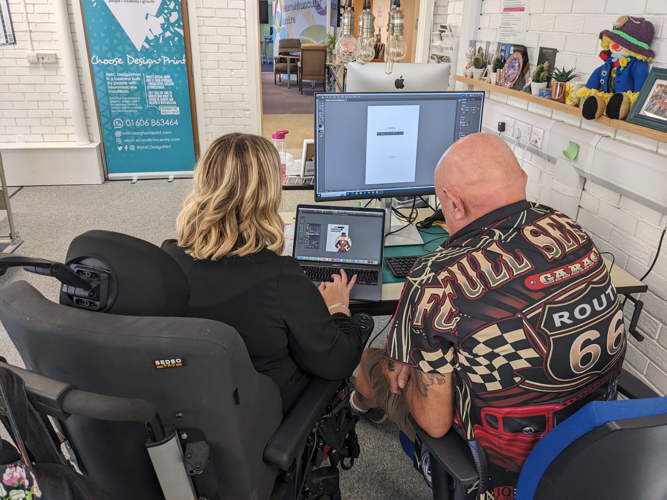 View over the shoulder of a man and woman working together at a computer.